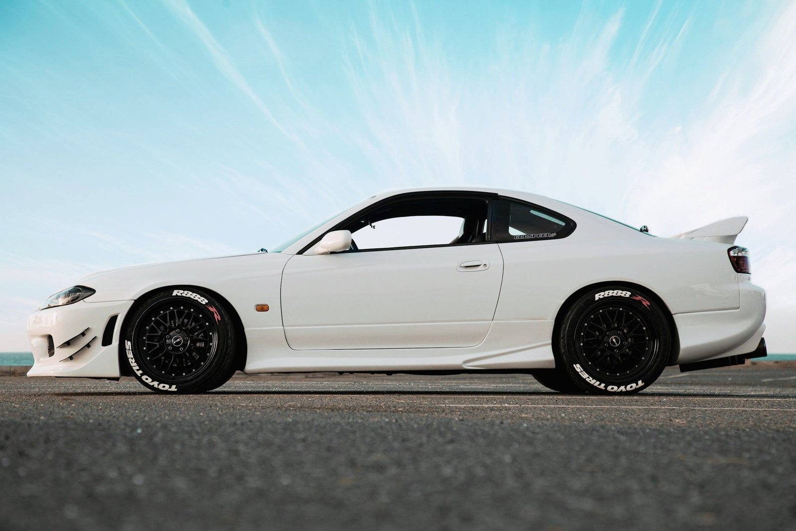 White Nissan Silvia S15 against a bright sky