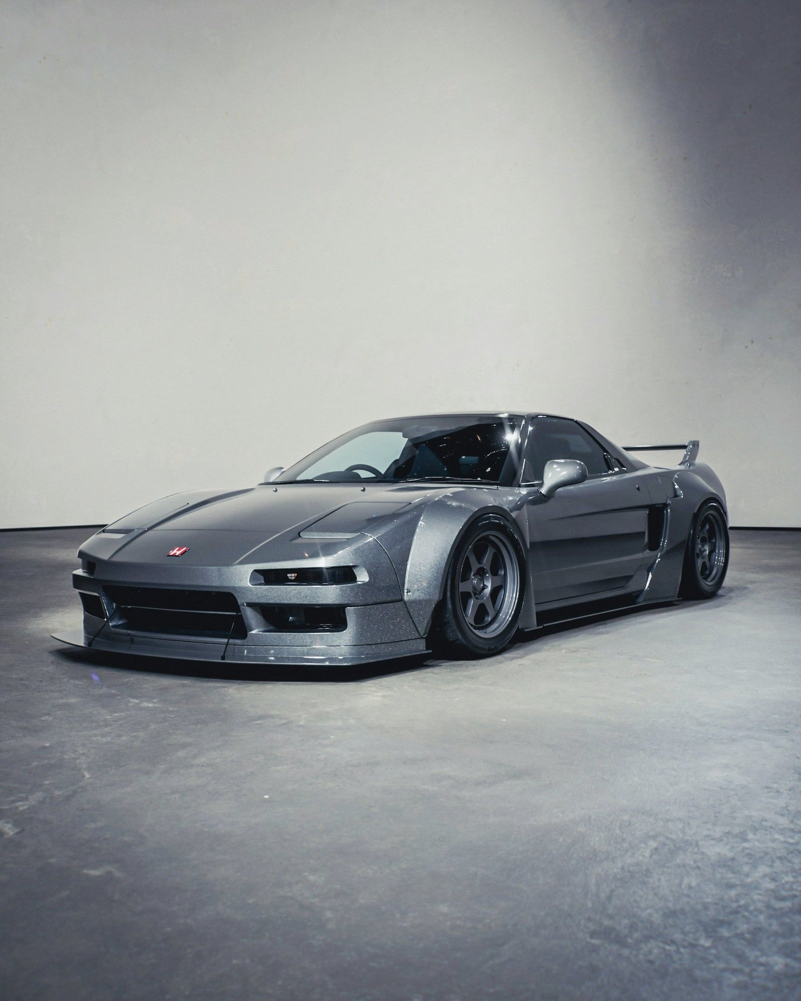 Grey widebody Honda NSX in a minimal interior