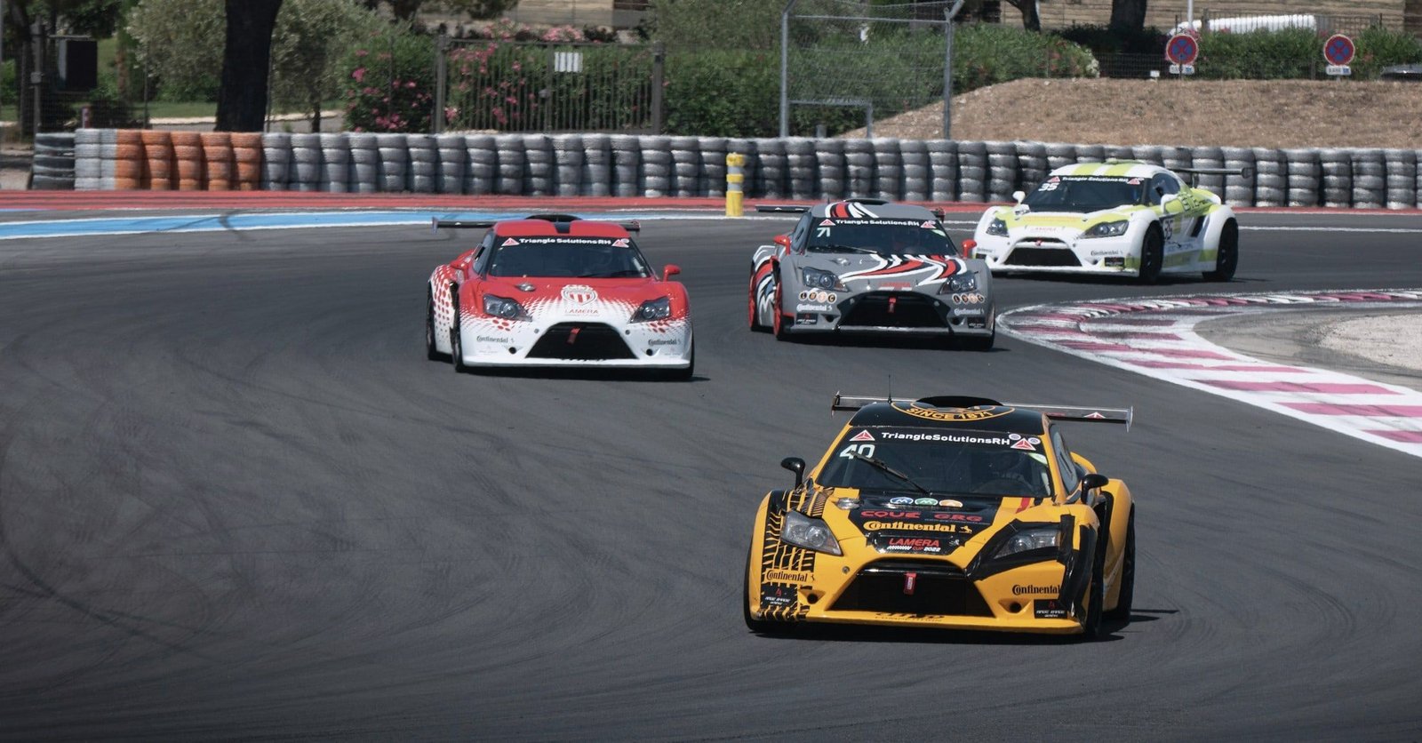 GT race cars cornering at a circuit