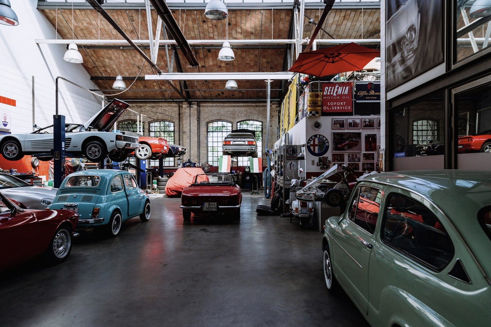 Tidy workshop hall with lifts and classic cars